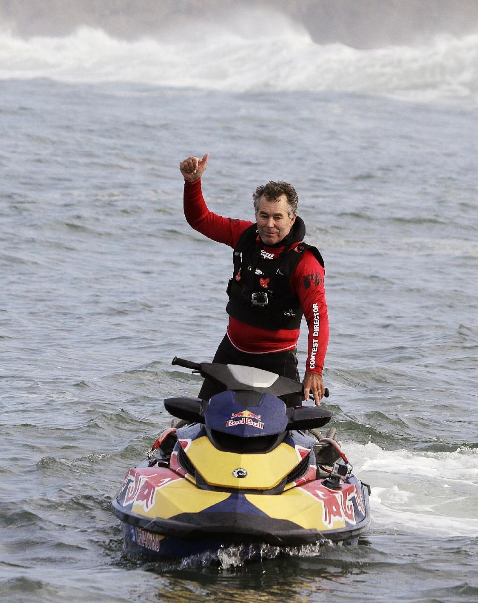 Contest director and founder Jeff Clark gives a thumbs up at the start of the second heat of the first round of the Mavericks Invitational big wave surf contest Friday, Jan. 24, 2014, in Half Moon Bay, Calif. (AP Photo/Eric Risberg)