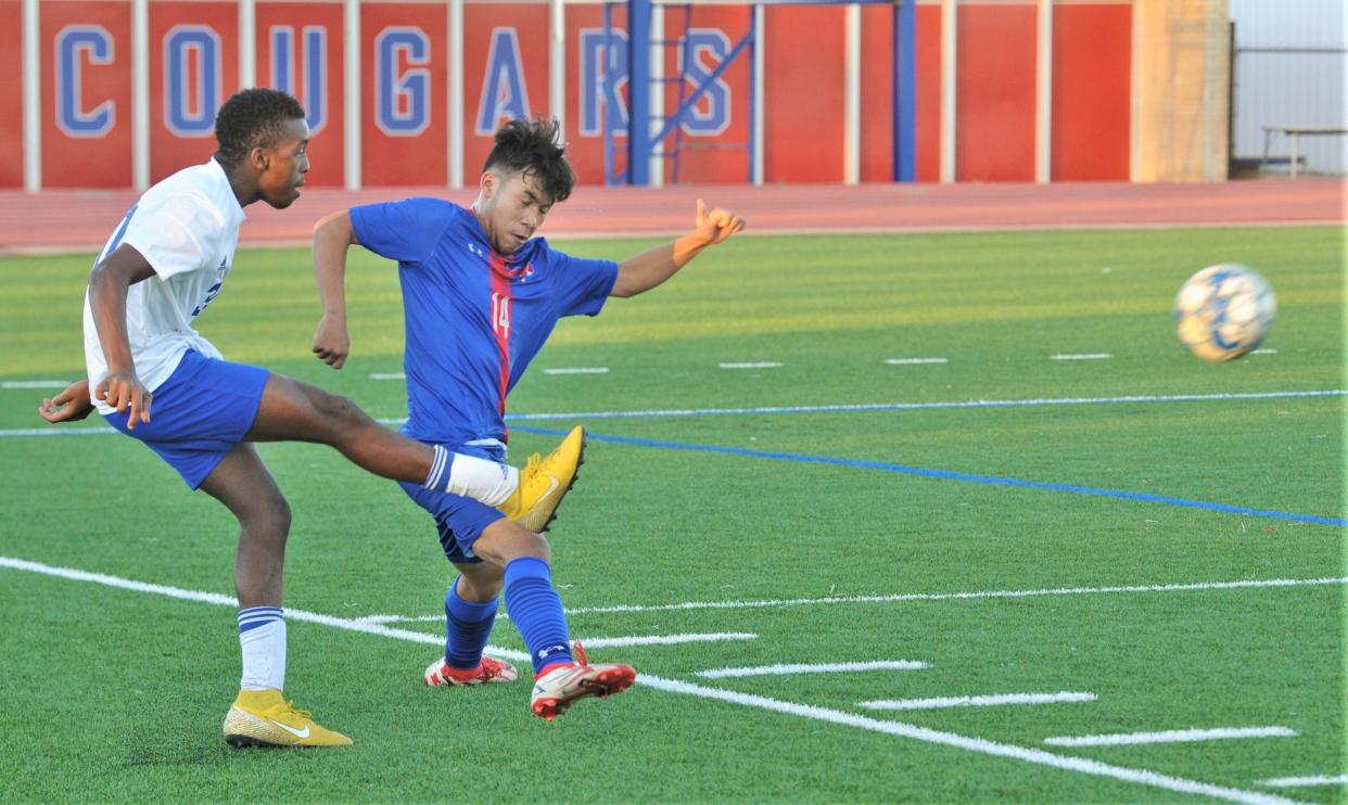 Cooper's Joe Cortes, right, defends as San Angelo Lake View's Elvis Koech kicks the ball in the first half. Cooper beat the Chiefs 4-2 in the nondistrict game Friday, Jan. 29, 2022, at the Cooper High School field.