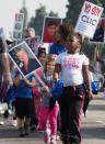 Schoolgirls march in Los Angeles where this year's parade theme was "When They Go Low, We Go High," inspired by a speech by former first lady Michelle Obama