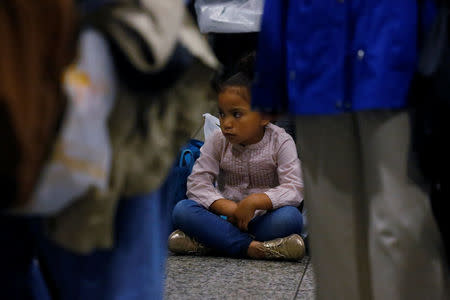 A child sits on the floor of Pennsylvania Station in the Manhattan borough of New York City, New York, U.S. May 22, 2017. REUTERS/Carlo Allegri