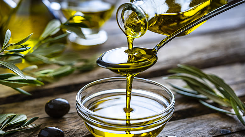 Pouring olive oil into bowl