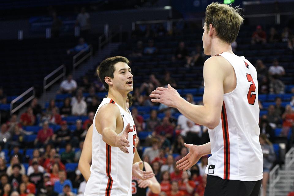 Ball State's Quinn Isaacson (left) celebrates with Kaleb Jenness during the semifinal round of the men's National Collegiate volleyball championships against Hawai'i at UCLA's Pauley Pavilion May 5, 2022.