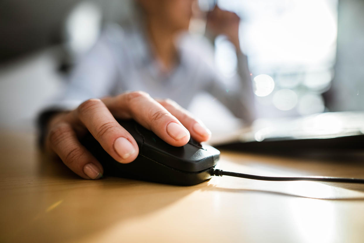 mouse jiggler Close up of unrecognizable businesswoman using computer mouse on a desk. Copy space.