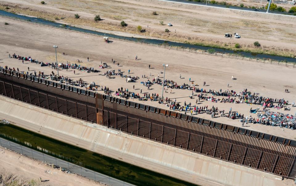 Migrants form lines outside the border fence waiting for transportation to a U.S. Border Patrol facility in El Paso, Texas, on, May 10, 2023. President Joe Biden’s administration on May 11 will begin denying asylum to migrants who show up at the U.S.-Mexico border without first applying online or seeking protection in a country.