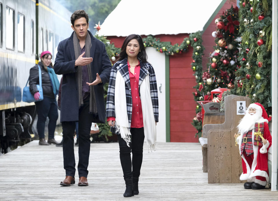 This image released by CBS shows Neal Bledsoe and Liza Lapira in a scene from "Must Love Christmas," airing Sunday, Dec. 11. (Bettina Strauss/CBS via AP)