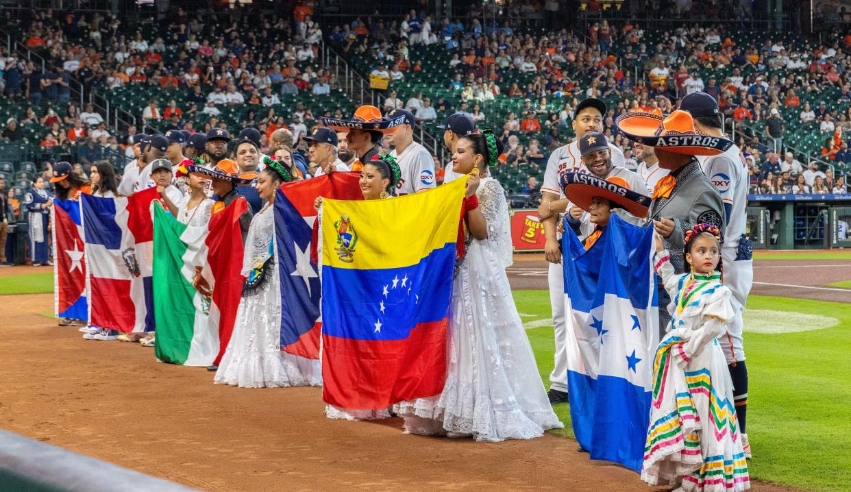 Sep 23, 2023; Houston, Texas, USA; Houston Astros stand next to their nations flag in honor of Hispanic Heritage Month before the Astros played against the Kansas City Royals at Minute Maid Park. Mandatory Credit: Thomas Shea-USA TODAY Sports