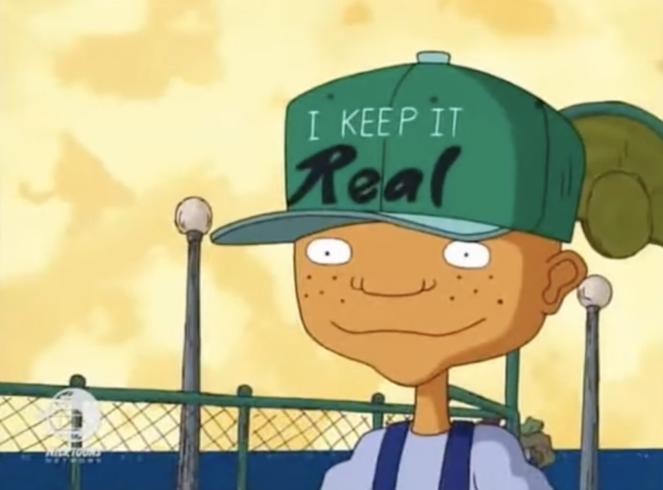 Maurice from Rocket Power with a hat that says "I keep it real"