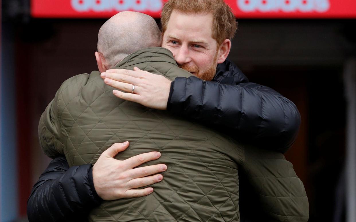 The Duke of Sussex is greeted by former Welsh rugby player Gareth Thomas - AFP