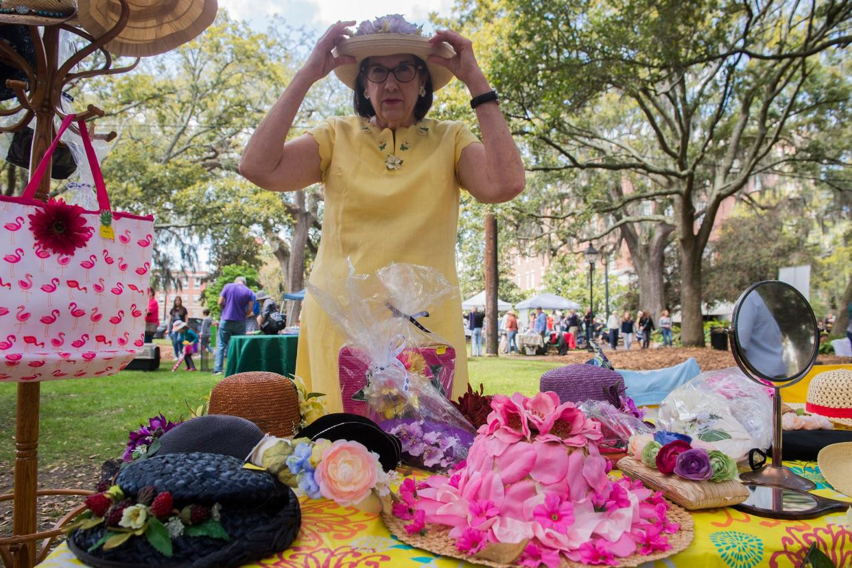 Montford, the owner and artist behind The Purveyor of Happiness business, shows off her wares at the Flannery O'Connor Parade and Street Fair in Lafayette Square.