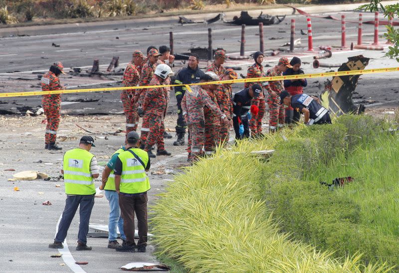 Authorities inspect the scene of a plane crash in Shah Alam