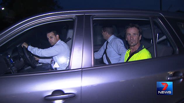 Gary Hudson being driven away by detectives.