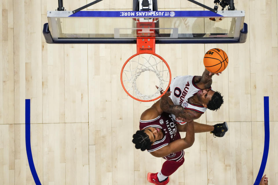 Auburn guard K.D. Johnson (0) takes a shot as South Carolina forward Collin Murray-Boyles (30) defends during the first half of an NCAA college basketball game at the Southeastern Conference tournament Friday, March 15, 2024, in Nashville, Tenn. (AP Photo/John Bazemore)