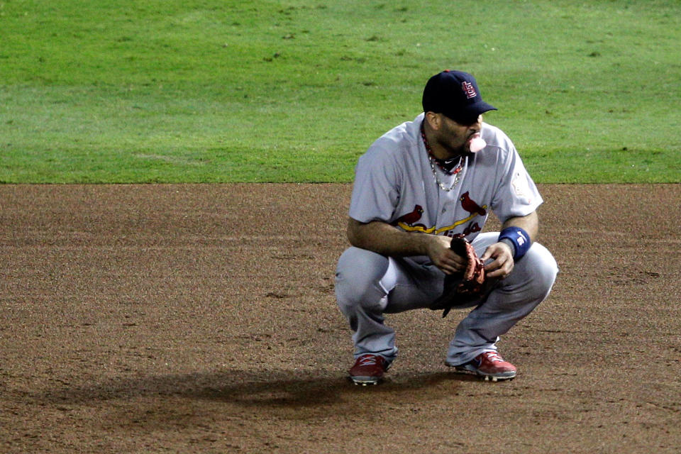 ARLINGTON, TX - OCTOBER 23: Albert Pujols #5 of the St. Louis Cardinals croutches on the field during Game Four of the MLB World Series against the Texas Rangers at Rangers Ballpark in Arlington on October 23, 2011 in Arlington, Texas. (Photo by Rob Carr/Getty Images)