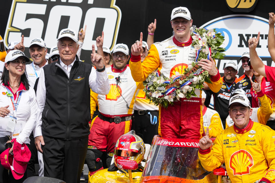 Josef Newgarden celebrates with his team and car owner Roger Penske, left, after winning the Indianapolis 500 auto race at Indianapolis Motor Speedway in Indianapolis, Sunday, May 28, 2023. (AP Photo/Michael Conroy)