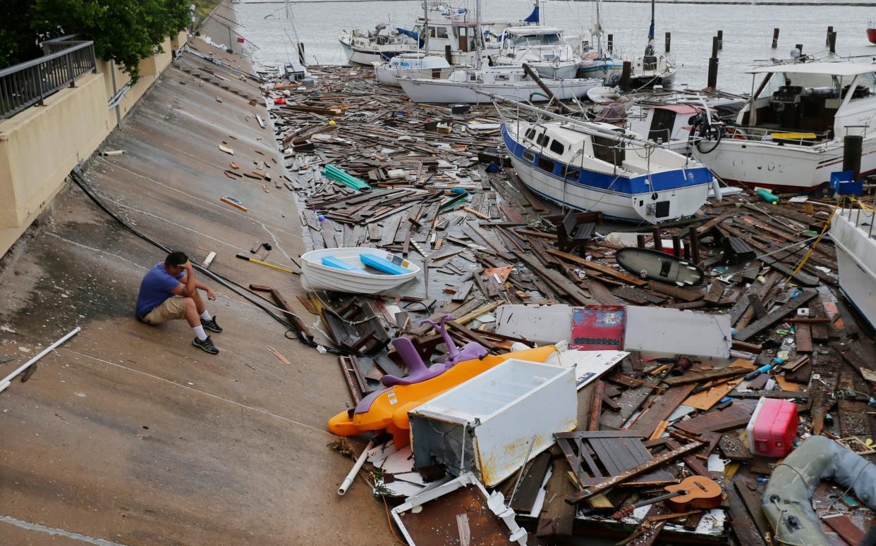 Allen Heath surveys the damage to a private marina in Corpus Christi, Texas after it was hit by Tropical Storm Hanna, which was downgraded from a hurricane as it hit land: AP