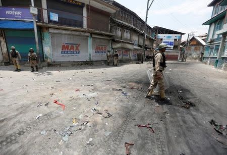 Policemen guard a street during a protest against the killing of Burhan Wani, a separatist militant leader, in Srinagar, July 10, 2016. REUTERS/Danish Ismail