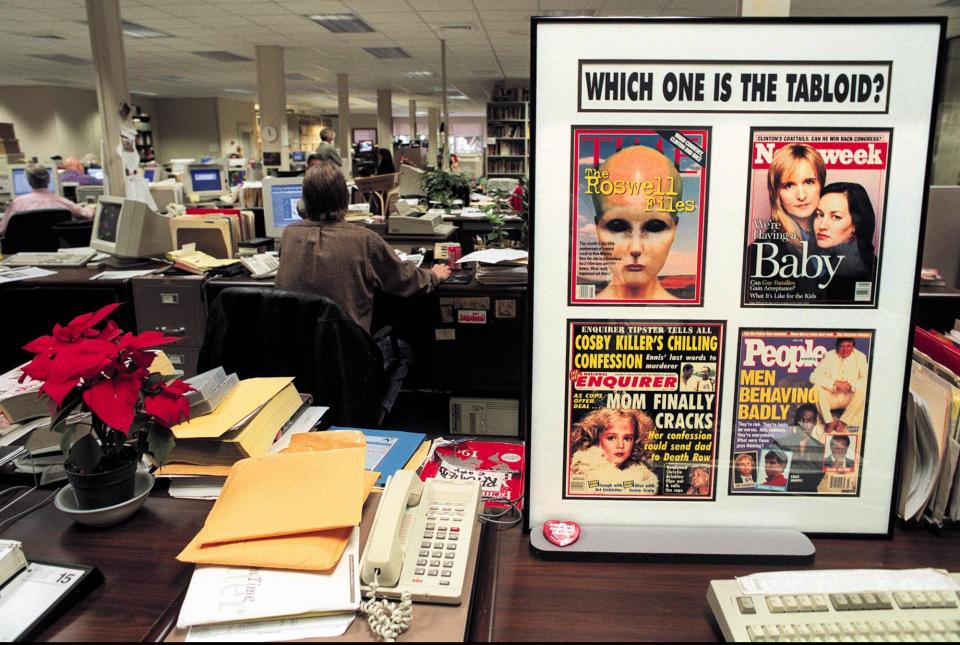 Lantana...December 15, 1998...In the newsroom of the National Enquirer, framed covers of Time, Newsweek, People and the National Enquirer make a point  how news content in mainstream publications is being blurred more towards the sensationalism of publications like the Enquirer.  Photo by David Spencer/The Palm Beach Post