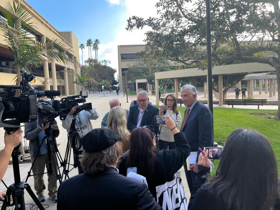 Ron Bamieh, at right, the attorney for Loay Alnaji, 50, talks to reporters outside Ventura County Superior Court on Friday.