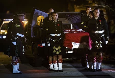 Pallbearers from the Argyll and Sutherland Highlanders of Canada regiment carry the remains of Corporal Nathan Cirillo at a funeral home in Hamilton, October 24, 2014. REUTERS/Mark Blinch