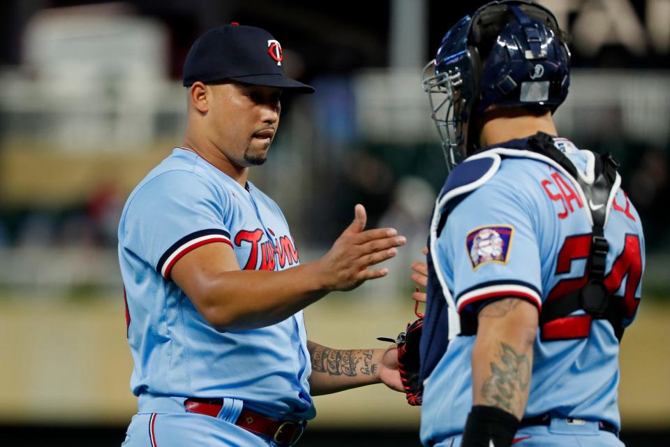 Minnesota Twins relief pitcher Jhoan Duran, left, celebrates with catcher Gary Sanchez after they defeat the Chicago White Sox in the ninth inning of a baseball game Tuesday, Sept. 27, 2022, in Minneapolis. The Twins won 4-0. (AP Photo/Bruce Kluckhohn)