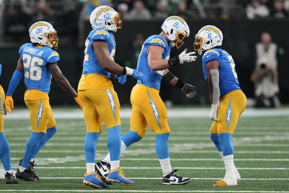 Los Angeles Chargers linebacker Joey Bosa (97) reacts with Los Angeles Chargers linebacker Eric Kendricks (6) during the third quarter of an NFL football game against the New York Jets, Monday, Nov. 6, 2023, in East Rutherford, N.J. (AP Photo/Seth Wenig)