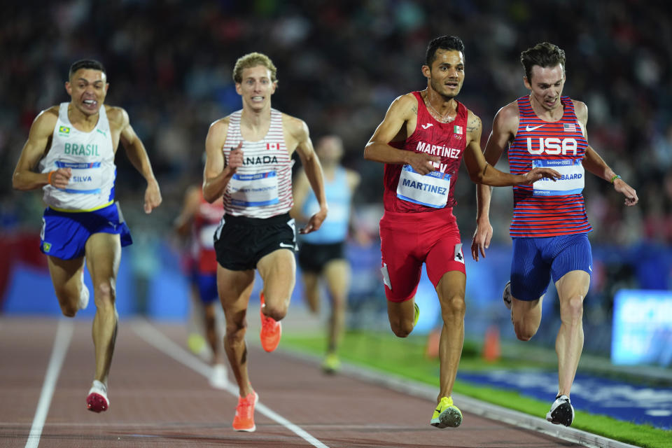 Mexico's Fernando Martinez wins the gold medal in the men's 5000-meters final at the Pan American Games in Santiago, Chile, Tuesday, Oct. 31, 2023. Kasey Knevelbaard of the United States won the silver medal, Canada's Charles Philibert-Thiboutot, the bronze medal and Brazil's Altobeli Da Silva finished fourth. (AP Photo/Natacha Pisarenko)