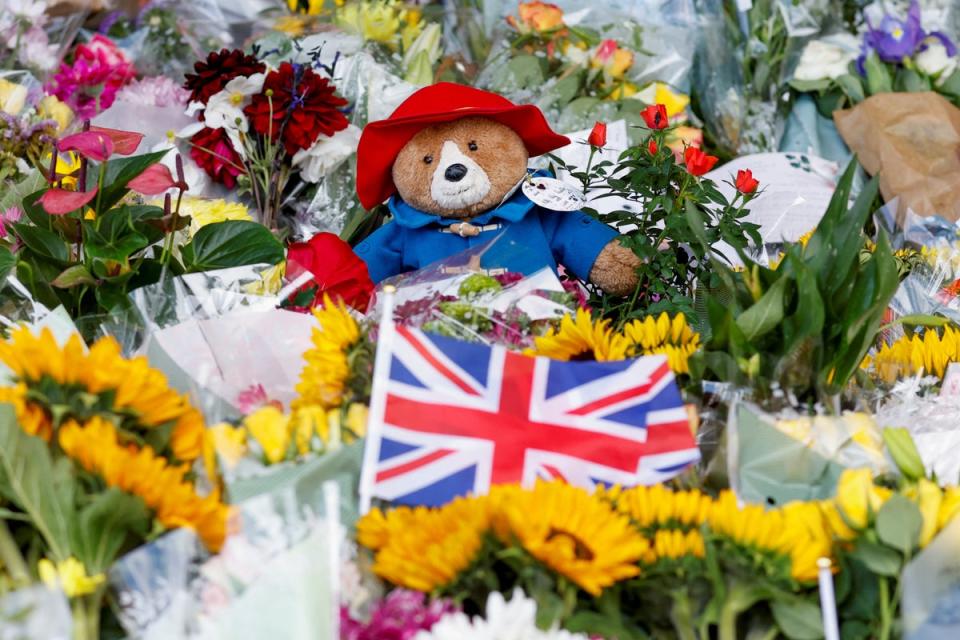 Many mourners opted to leave stuffed toys and marmalade sandwiches outside royal residences across the UK (REUTERS)