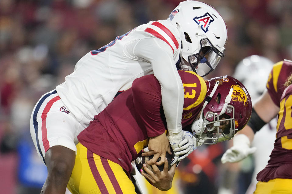 Southern California quarterback Caleb Williams (13) is sacked by Arizona defensive lineman Russell Davis II during the first half of an NCAA college football game Saturday, Oct. 7, 2023, in Los Angeles. (AP Photo/Marcio Jose Sanchez)