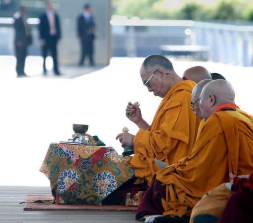 Tibetan spiritual leader the Dalai Lama, seen here performing a ritual at the Anacostia River in Washington, DC, on July 16. The Dalai Lama said that Chinese leaders show through their strident denunciations of him that they are "childish" and lack their full brains, but voiced hope that China will change in time