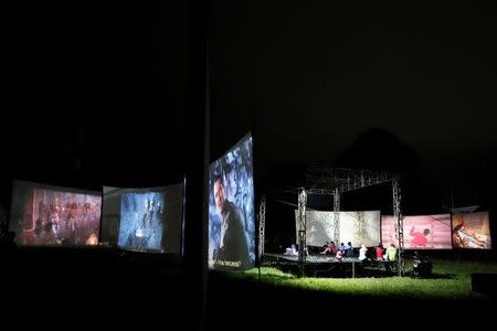 People watch films during a wedding party in Bogor, Indonesia, March 19, 2017. REUTERS/Beawiharta/Files