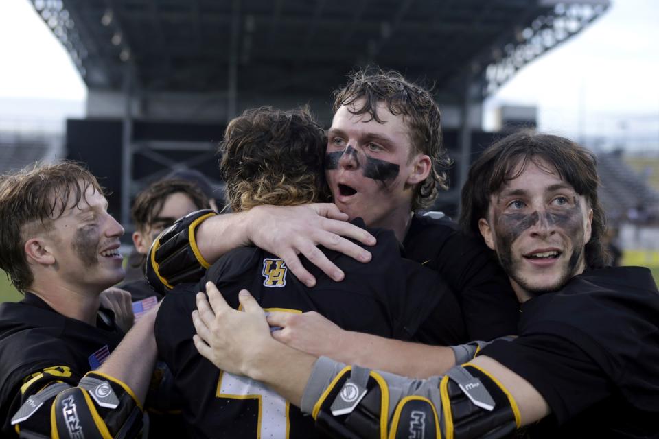 Upper Arlington's Evan D'Herete, facing hugs Chris Mazzaferri as he celebrates with other teammates Charlie Paxton, left, and Sam Favret following a 12-10 win over Dublin Jerome in the OHSAA Division I boys lacrosse state championship game June 4 at Historic Crew Stadium in Columbus.