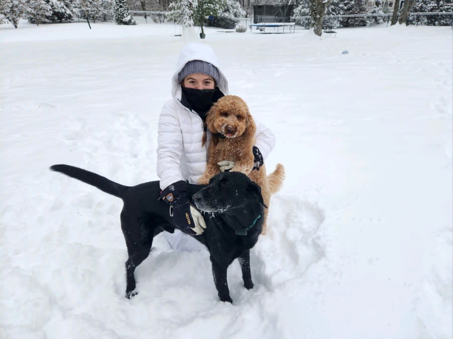 Ella Tirrill playing in the snow with her 3-year-old golden doodle, Mia, and her 9-year-old lab, Drake (Courtesy: Stacey Tirrill)