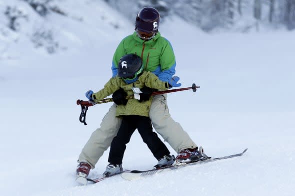 Adult skiing with a child