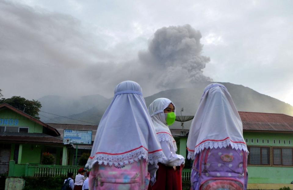 Students are seen at school as Mount Marapi volcano spews volcanic ash as seen from Nagari Batu Palano in Agam, West Sumatra (via REUTERS)