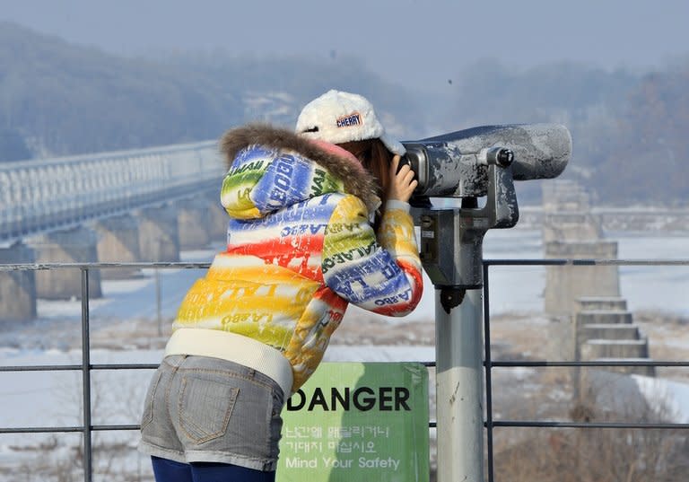 A visitor looks at North Korea through binoculars at Imjingak in Paju near the demilitarized zone dividing the two Koreas on February 13, 2013. "The prospect that the North will sell highly-enriched uranium, nuclear weapons designs or even nuclear weapons to all comers, is not a happy thought if you live in one of America's cities," Robert Gallucci, president of the MacArthur Foundation, said