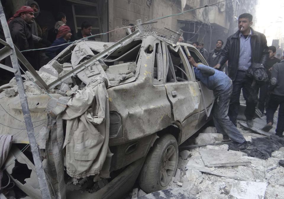 Residents look for survivors at a damaged site after what activists said was an air strike from forces loyal to Syria's President Bashar al-Assad in the Karam Al-Beik area of Aleppo