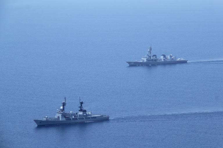 Japan Maritime Self Defense Force Escort Division Two JS Harusame (R) and the BRP Ramon Alcaraz (L) of the Philippine Navy during a joint naval exercise on May 12, 2015 near a Philippine-claimed shoal now under Chinese control in the South China sea