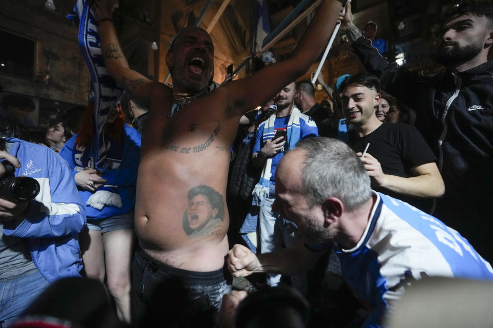 Napoli fans celebrates after Napoli's Victor Osimhen scored his side's first goal as they watch a screen live broadcasting Udinese Napoli Serie A soccer match, in Naples, Italy, Thursday, May 4, 2023. For the third time in five days, Napoli fans are hoping and preparing to celebrate the Italian league soccer title. (AP Photo/Andrew Medichini)