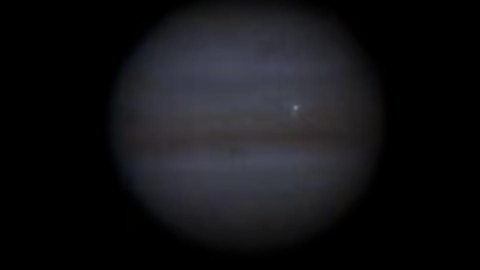 A true color image of some kind of space rock slamming into Jupiter.