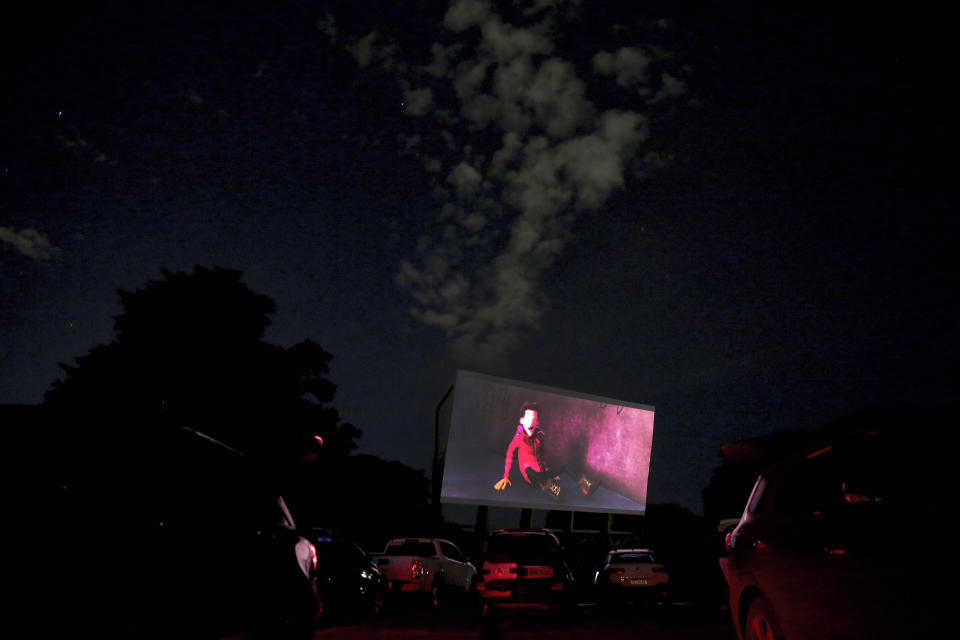 A screen plays a movie at a drive-in movie theater where drivers must leave one space empty between them amid the new coronavirus pandemic in Brasilia, Brazil, May 13, 200. The drive-in was closed at the start of the pandemic but reopened to the public at the start of April. (AP Photo/Eraldo Peres)