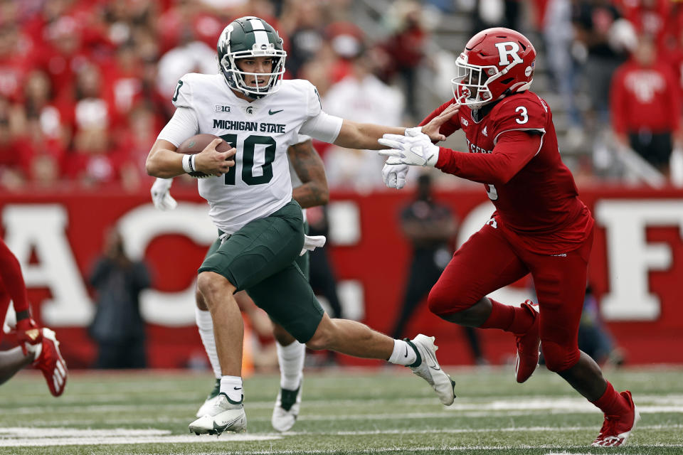 Michigan State quarterback Payton Thorne (10) runs away from Rutgers linebacker Olakunle Fatukasi (3) during the second half of an NCAA college football game Saturday, Oct. 9, 2021, in Piscataway, N.J. Michigan State won 31-13. (AP Photo/Adam Hunger)