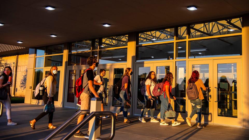 With masks on, students head into Edgewood High School in August 2020 for the first day of the new school year.
