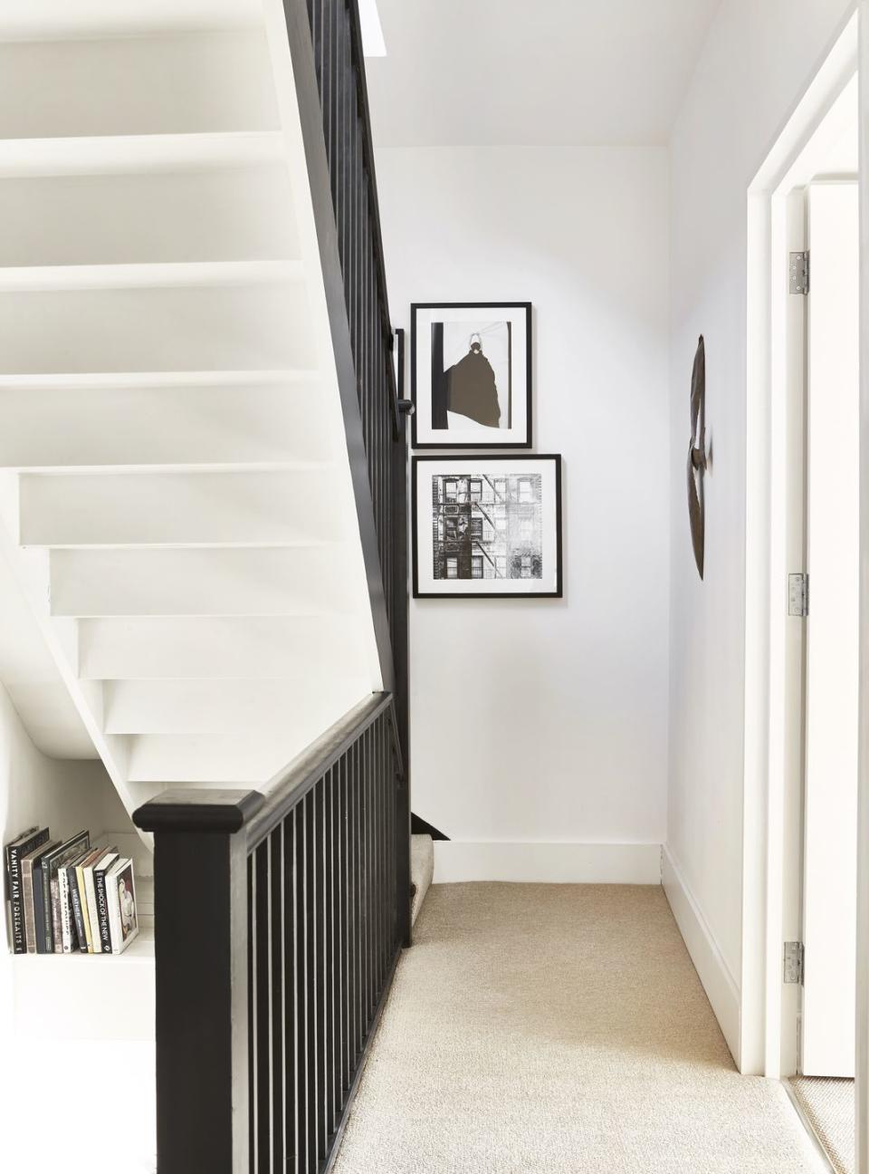 a staircase with pictures on the wall