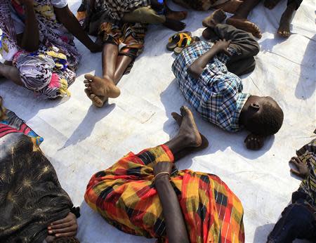 Displaced people rest on the floor as they wait for medical attention at an emergency clinic run by Medecins Sans Frontieres (MSN) at Tomping camp in Juba, where some 15,000 displaced people who fled their homes are sheltered by the United Nations, January 7, 2014. REUTERS/James Akena