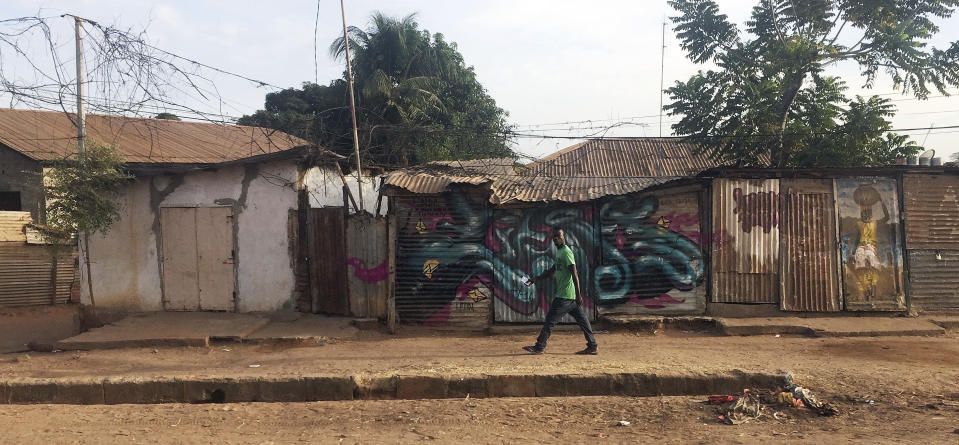 A man walks in Gambia's capital Banjul Tuesday Jan. 17, 2017. Gambia's President Yahya Jammeh declared a state of emergency just two days before he is supposed to cede power after losing elections last month to President-elect Adama Barrow in the December 2016 election. Barrow is vowing to take power Thursday Jan. 19, despite Jammeh's refusal to leave. (AP Photo)