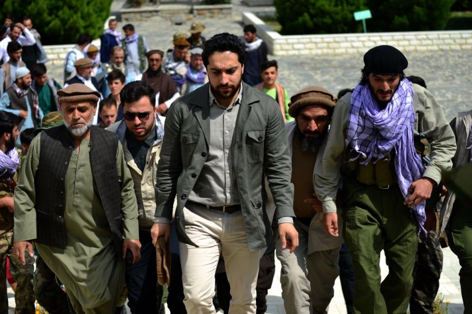 Massoud (centre) arrives to address a gathering at the tomb of his late father in Panjshir province in July 2021, before Kabul fell to the Taliban (AFP via Getty)