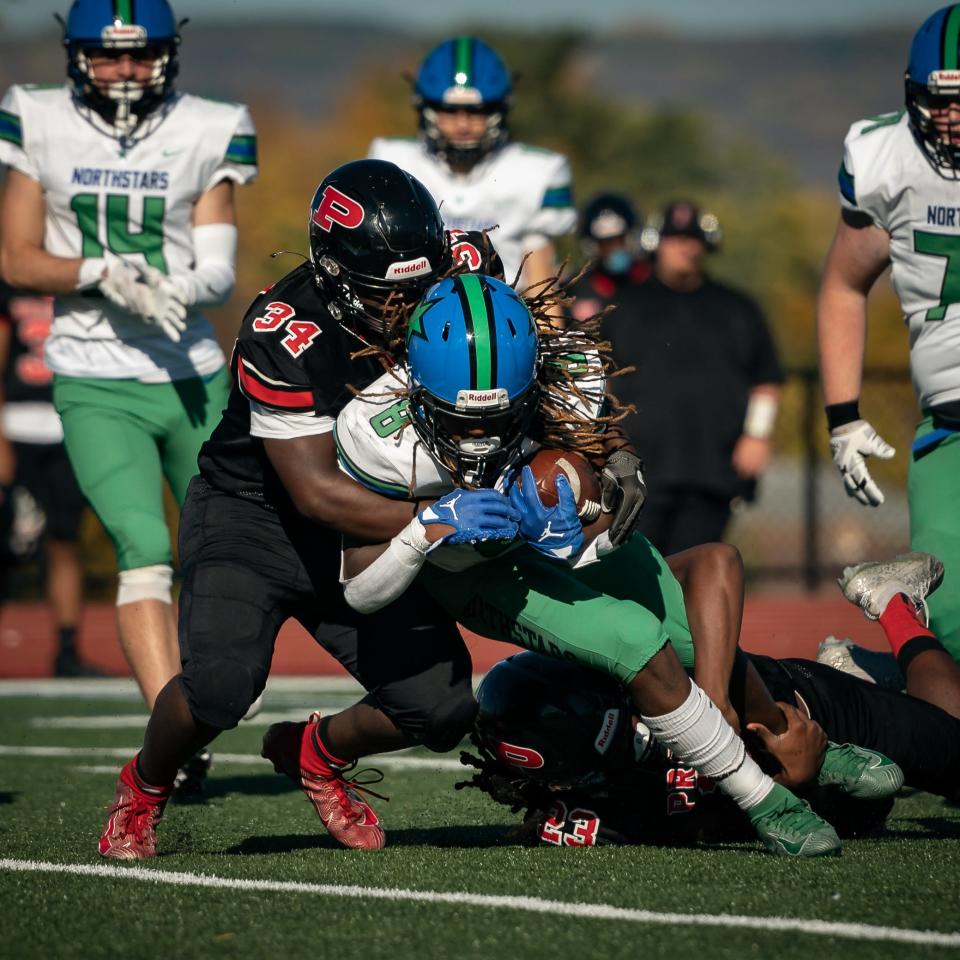 Cicero-North Syracuse's Anthony Johnson gets tackled by Utica-Proctor's Jquan Simmons Saturday afternoon.