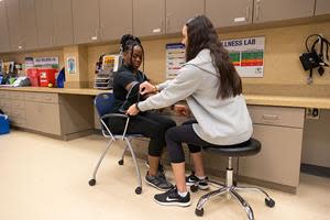 One of UWG's health experts examines a student at the university's wellness lab.