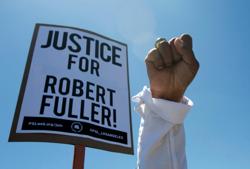 A demonstrator raises his fist during a protest rally for Robert Fuller whose body was found hanging from a tree a block from Palmdale City Hall, in the aftermath of the death in Minneapolis police custody of George Floyd, in Palmdale, California, U.S., June 13, 2020.  (Ringo Chiu/Reuters)