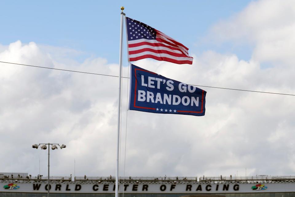 A "Let's go Brandon" flag flies below the American flag Friday, Feb. 18, 2022, at Daytona International Speedway in Daytona Beach, Fla. (AP Photo/Chris O'Meara)